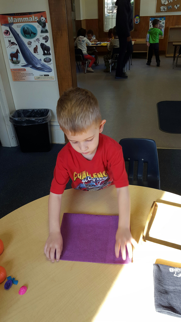 A boy at a classroom table